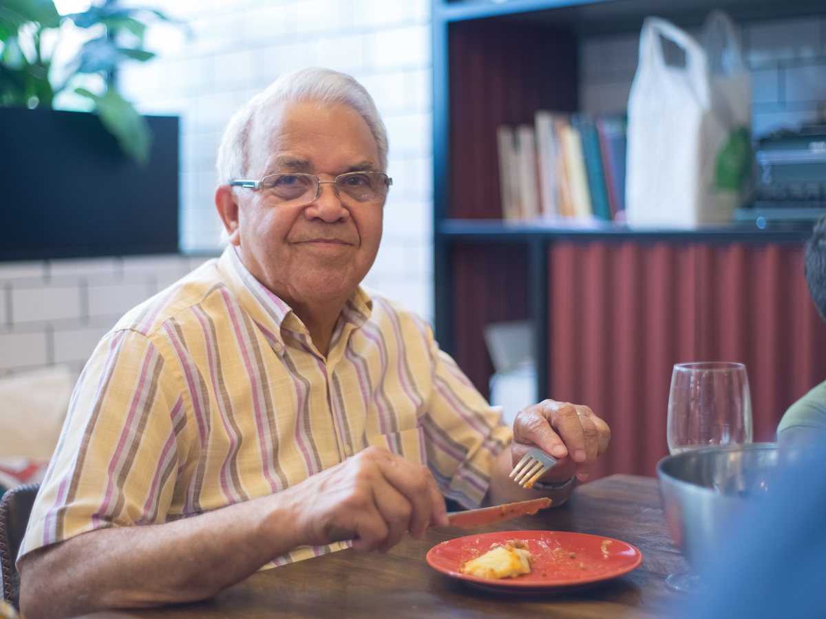 A gentleman enjoying a meal at a restaurant table